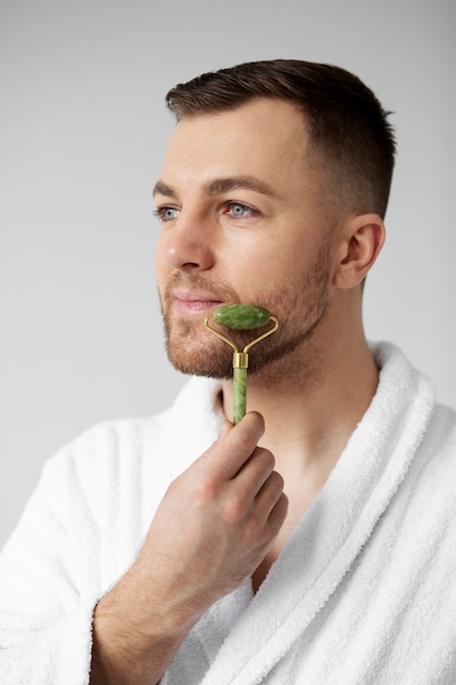 Young man applying his anti aging treatment