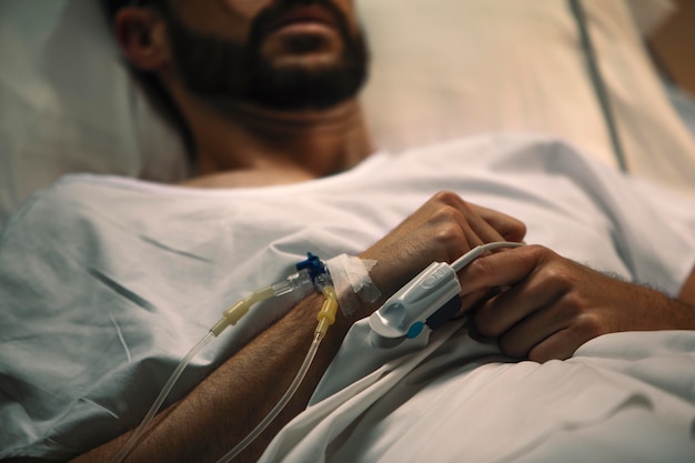 Young man being ill in a hospital bed