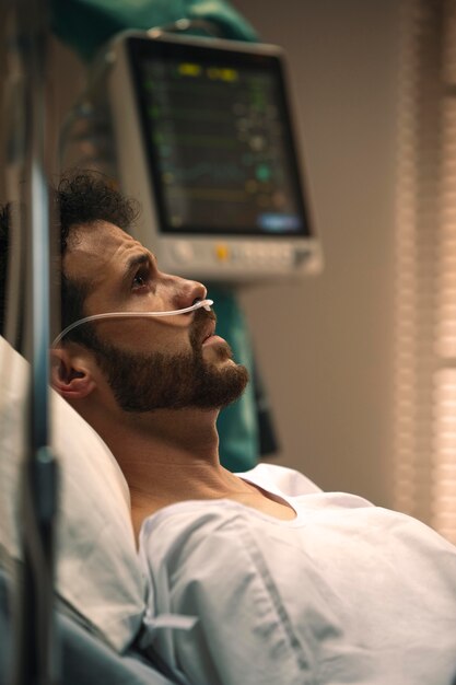 Young man being ill in a hospital bed