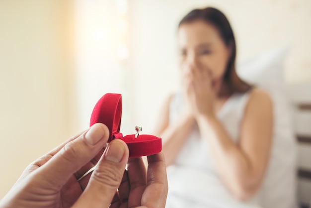 Free photo young man bringing ring box for his girlfriend at his home