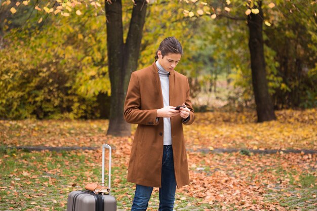 Young man checking his phone in the park