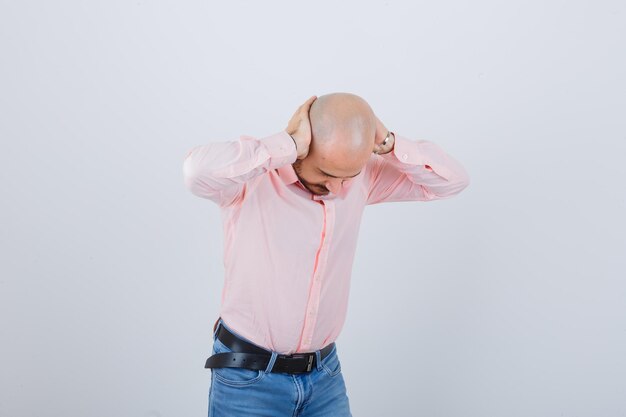 Free photo young man covering ears with hands