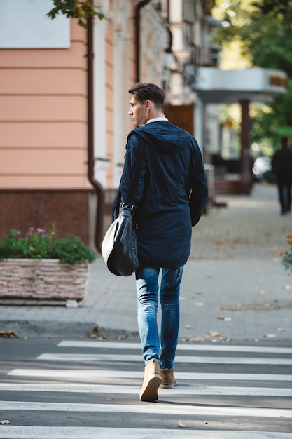 Young man cross the street