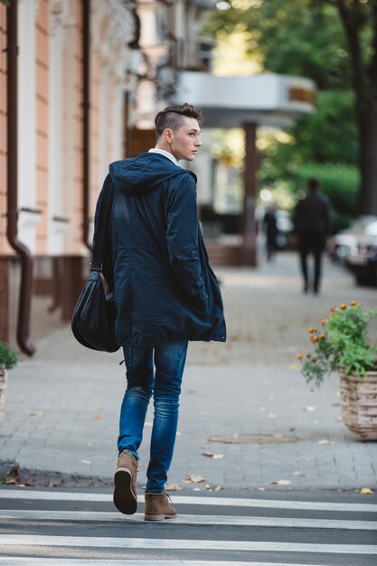 Young man cross the street