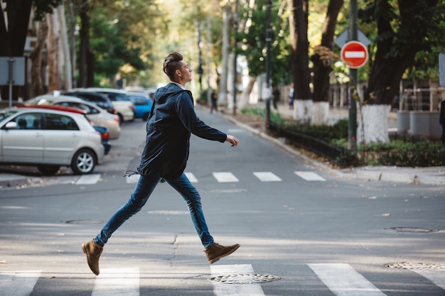 Free photo young man cross the street