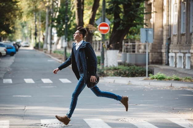 Young man cross the street