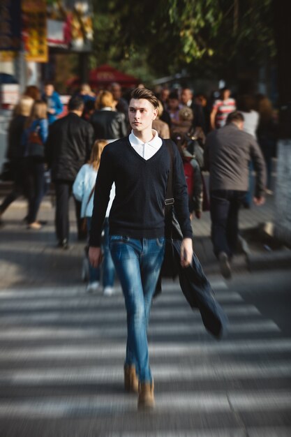 Young man cross the street