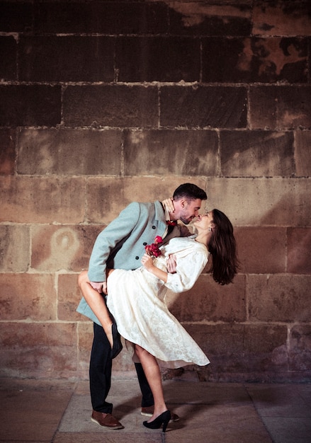 Free Photo young man dancing with pretty woman in street 