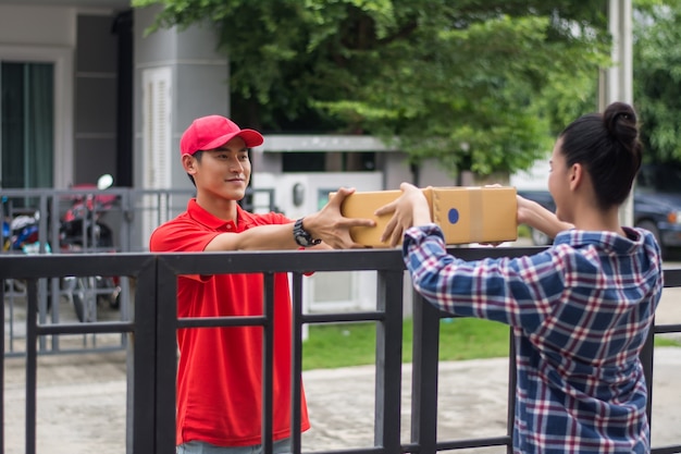 Young man Delivering Package to customer at home. Delivery