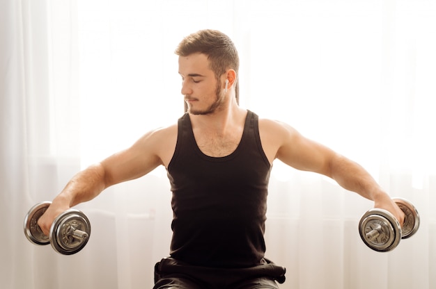 Free photo young man doing fitness exercise at home