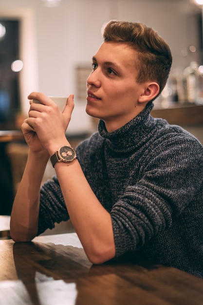 Young man drinking coffee in the cafe