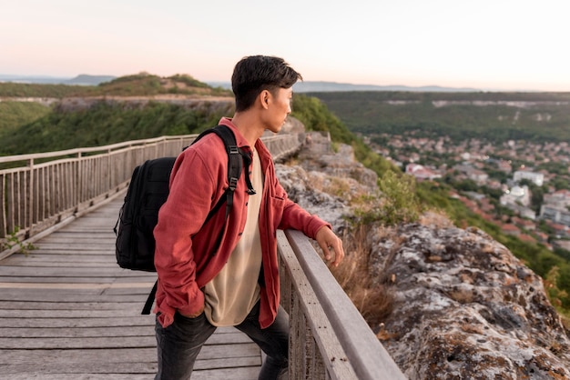 Free photo young man enjoying landscape