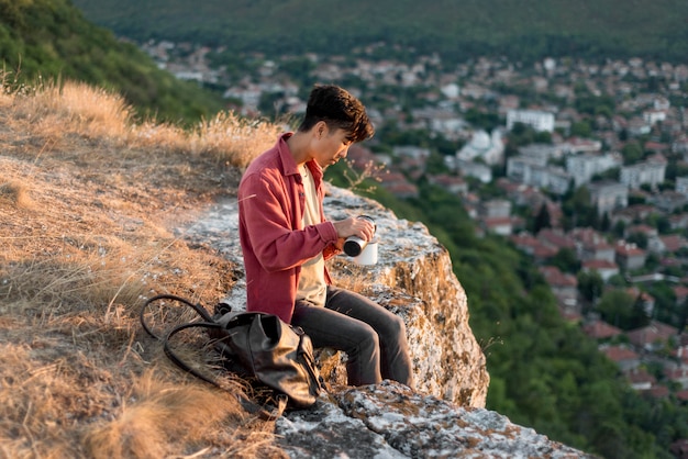 Free photo young man enjoying the landscape