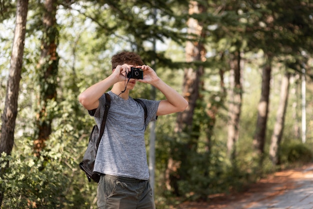 Free Photo young man enjoying walk in the forrest