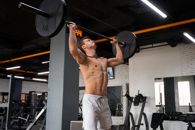 Young man exercising at the gym for bodybuilding