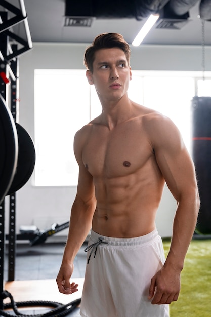 Young man exercising at the gym for bodybuilding