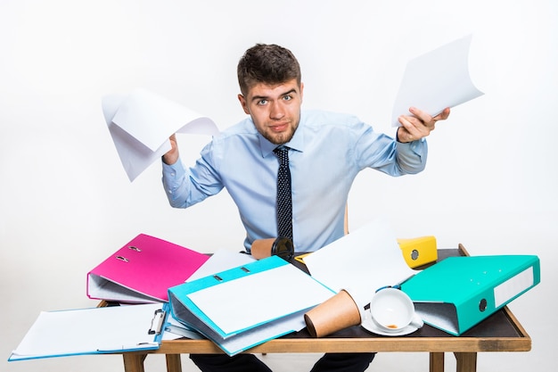 Free Photo the young man has a complete mess in the workplace