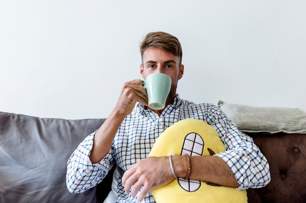 Free photo young man having a coffee