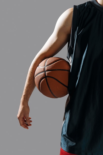 Young man holding his basketball