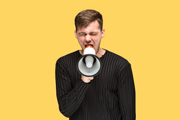 Free photo the young man holding a megaphone