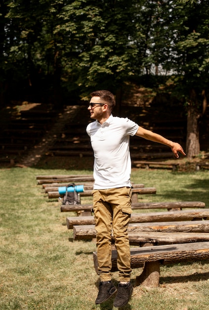 Young man jumping over wooden benches