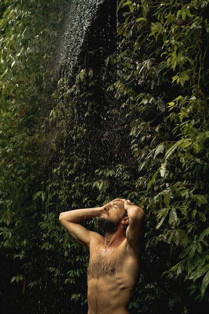 Free photo young man in the jungle bali indonesia