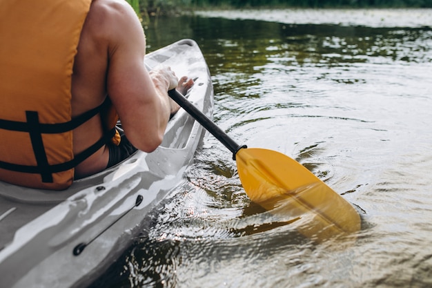 Free photo young man kayaking on the river