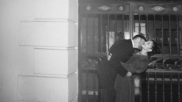 Free photo young man kissing and bending attractive woman on street