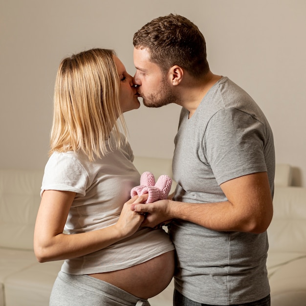 Young man kissing his pregnant wife