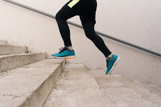 Young man legs doing interval workout on stairs