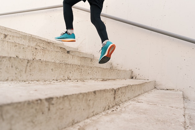 Free photo young man legs doing interval workout on stairs