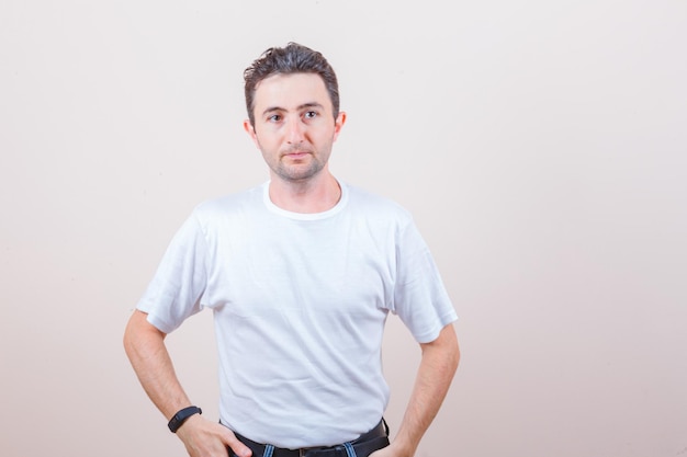 Young man looking away in white t-shirt and looking elegant