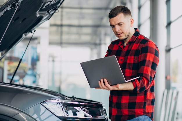 Young man making diagnostics of the vehicle