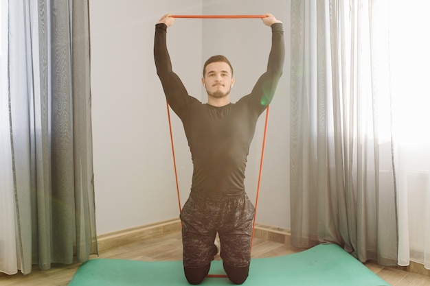 Free photo young man making sport exercises at home