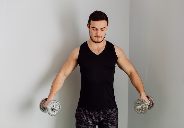 Young man making sport exercises at home