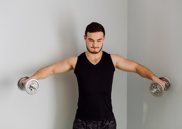 Free photo young man making sport exercises at home