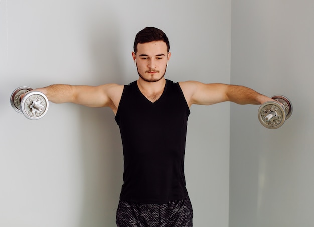 Young man making sport exercises at home