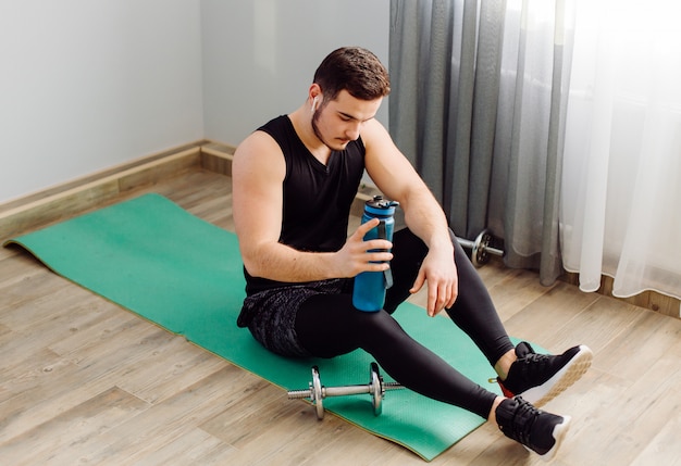 Young man making sport exercises at home