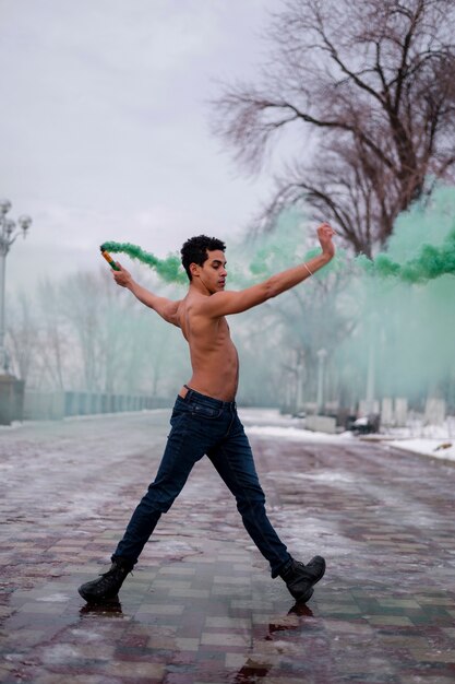 Young man performing ballet with powder color