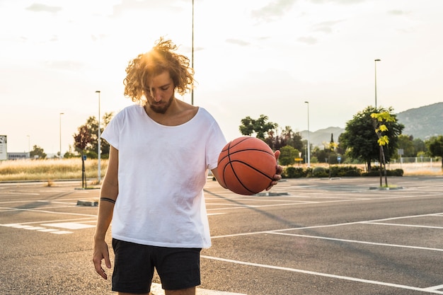 Young man playing basketball in court