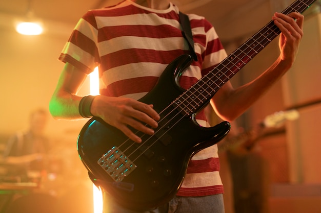 Young man playing guitar music at a local event