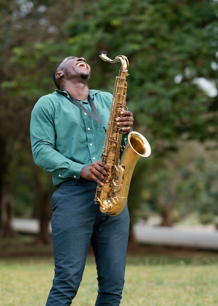 Free photo young man playing an instrument on international jazz day