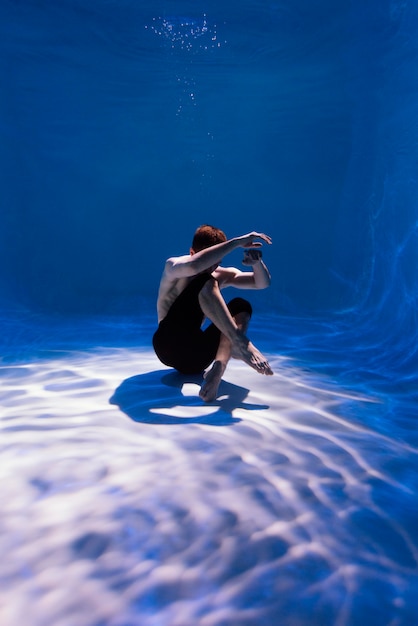 Free Photo young man posing submerged underwater