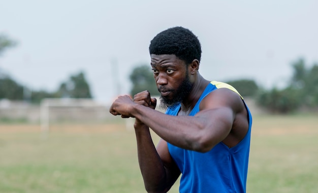 Young man practicing box outdoors