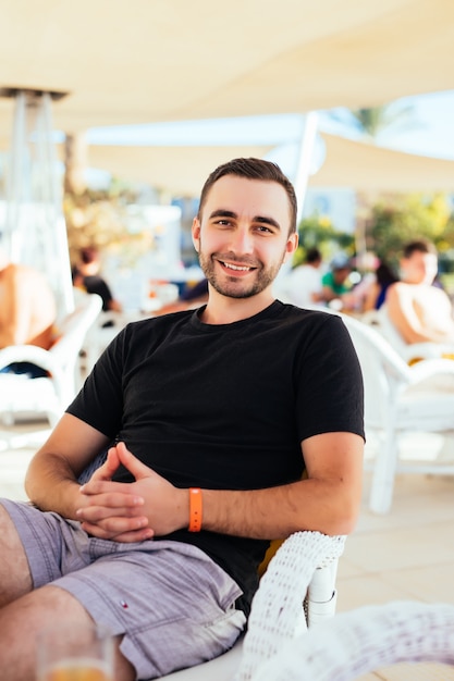 Young man relax at outdoor cafe.