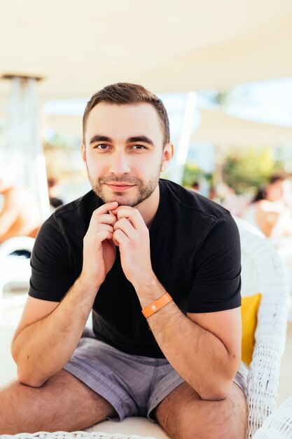 Young man relax at outdoor cafe.