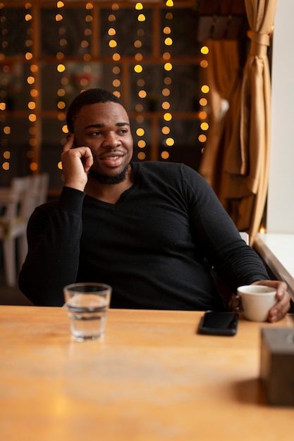 Young man at restaurant drinking coffee