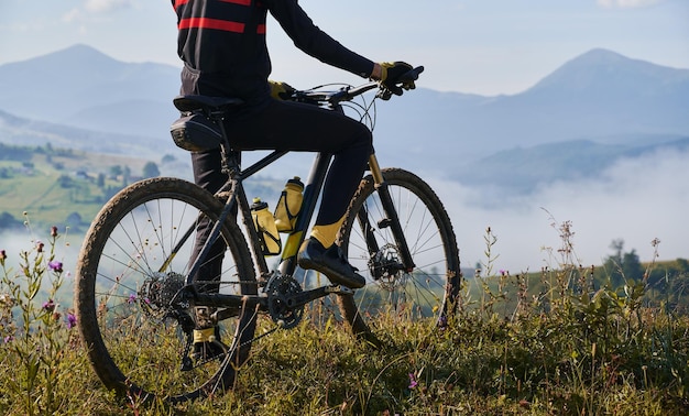 Young man riding a mountain bike downhill style