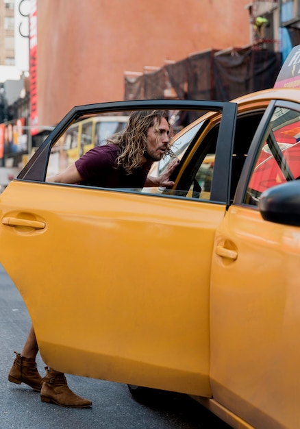 Free photo young man riding taxi in the city