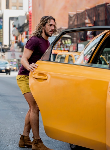 Free photo young man riding taxi in the city